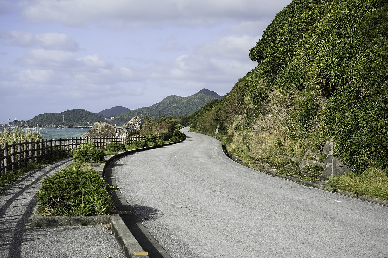 A real coastal road on Iheya Island, with sea and green mountains